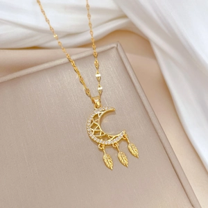 Luxurious gold moon dreamcatcher necklace with sparkling rhinestones on white silk fabric