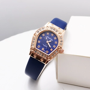 Detail of rose gold horseshoe case with crystals and blue leather strap on quartz watch