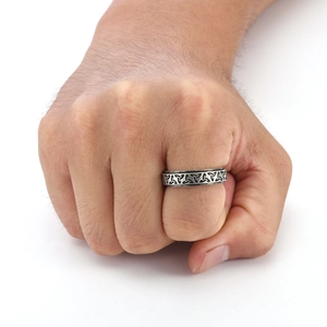 Close-up of vintage Viking Celtic knot spinner ring in antique silver on male hand