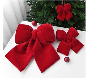 Detail of red velvet Christmas bows with soft texture for festive tree decoration