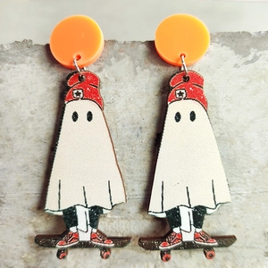 Detail of quirky Halloween ghost on a skateboard dangle earrings with orange stud