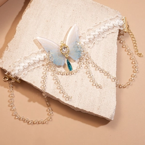 Macro view of crystal butterfly choker with lace band and blue teardrop pendant