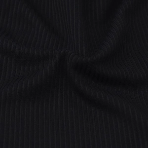 Gros plan macro sur le tissu en maille côtelée noire avec texture verticale et drapé doux