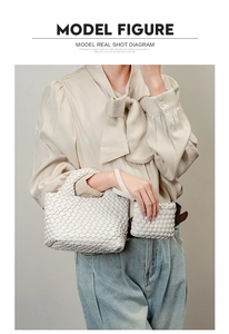 White hand-woven leather bucket bag with matching inner pouch shown on a model