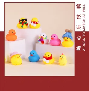 Collection of colorful rubber ducks with accessories on white geometric stands