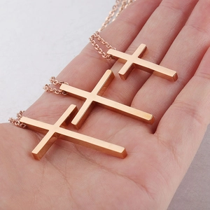 Detailed comparison of three polished stainless steel cross necklaces in rose gold and gold