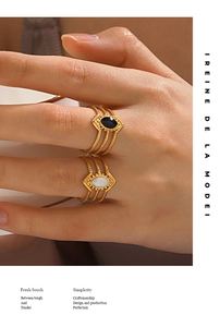 Close-up of gold-plated stainless steel hollow rings with black and white inlay