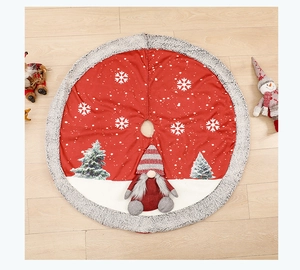 Close-up of red burlap Christmas tree skirt with white plush trim and 3D gnome doll detail