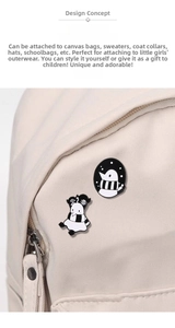Detailed close-up of cute penguin enamel pins on a canvas bag, creative metal badges