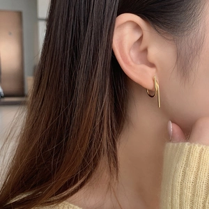 Close-up of minimalist gold S925 sterling silver geometric hook earrings on female model