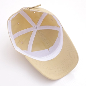 Internal view of a cotton baseball cap showing reinforced seams and adjustable strap buckle