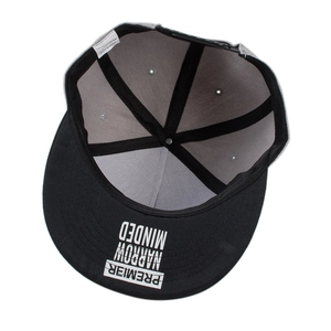 Detail of the embroidery under the brim and interior tag of the polyester baseball cap