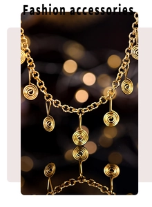 Fashionable gold stainless steel spiral charm necklace on a dark reflective surface