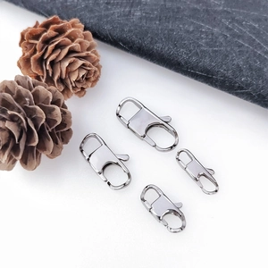 Detailed view of four silver stainless steel lobster clasps for DIY jewelry making