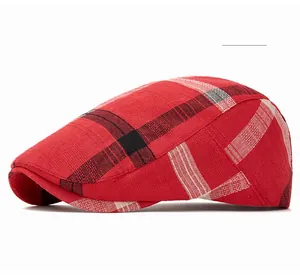 Detailed close-up of bright red plaid pattern on a vintage cotton newsboy cap fabric