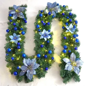 Detail of 2.7m Christmas garland with blue flowers and warm LED lights on pine needles