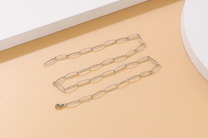 Detail of silver oval link chain necklace with polished finish and lobster clasp