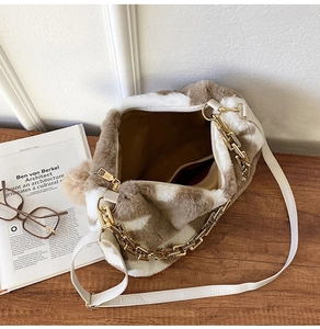Detail of plush animal print tote featuring golden chain and internal zipper pocket