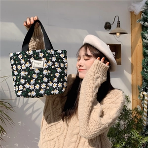 Floral embroidered black canvas tote bag with daisy pattern and pleasant time label