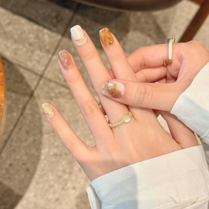 Baroque luxury press-on nails with amber glaze, pearls, and metallic lines accents