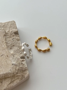 Close-up of textured S925 sterling silver rings in gold and silver finish with S925 hallmark