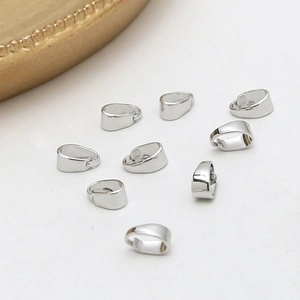 Macro shot of silver plated pinch bails for pendant necklace jewelry making connectors