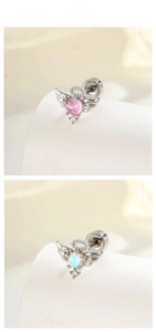 Detail of angel wing cartilage studs with pink and opal zircon in threaded ball back