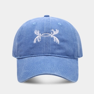 Detail of white antler embroidery on washed blue cotton vintage baseball cap