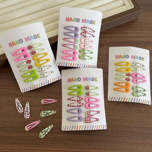 Set of 10 colorful mini fruit and floral pattern BB hair clips for kids on a card