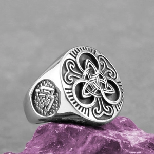 Macro view of Valknut and Celtic knot patterns on vintage stainless steel ring