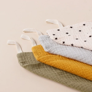 Detail of 4-pack muslin cotton baby face towels with convenient hanging loops