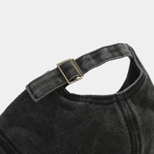 Detail of adjustable metal buckle and vintage washed cotton fabric on the baseball cap