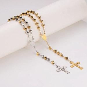 Elegant gold and silver cross pendant rosary necklaces on a white studio display