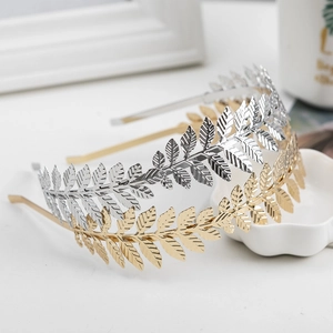Elegant gold and silver metal leaf headbands for women shown in a minimalist flat lay