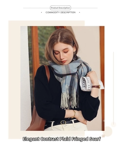 Detail of soft gray-blue plaid shawl scarf featuring long fringe and cashmere-like texture