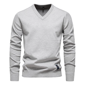 Detailed view of the V-neckline and soft knit texture of this light grey men's sweater