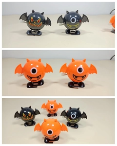 Detail of Halloween wind-up walking toys featuring black bat and orange monster designs