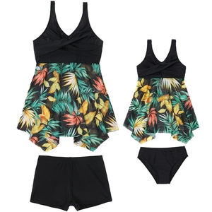 Detail of parent-child tankini set with tropical palm print and criss-cross bust design