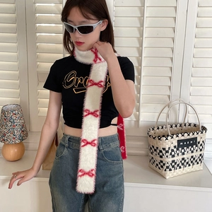 White skinny scarf with red bow patterns in soft plush fabric on a fashion model
