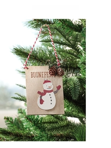 Close-up of wooden snowman ornament with pine cone hanging on a Christmas tree branch