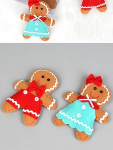Detailed view of handmade gingerbread man felt ornaments with red and blue festive outfits