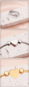 Macro view of braided stainless steel cable heart ring in gold and silver finish