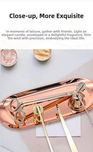 Rose gold and gold stainless steel candle care set with tray on a warm textured surface