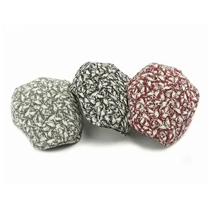Three retro newsboy caps with leaf patterns in grey, black and red on white background