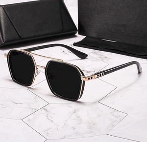 Detail of square black and gold sunglasses with double bridge and leather case