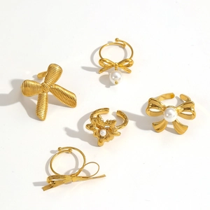 Gold titanium steel bow rings set with pearls and hollow floral patterns for women