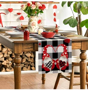 Close-up of Valentine gnome buffalo check table runner with heart prints on wood table