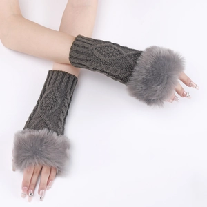 Detail of grey knitted arm warmers with faux fur trim and diamond cable pattern