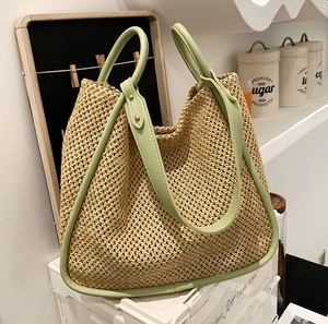 Large capacity woven straw tote bag with green faux leather handles and wood-tone texture