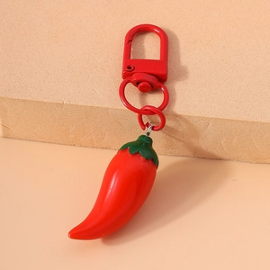 Creative red chili pepper keychain with matching metal spring clasp on beige background